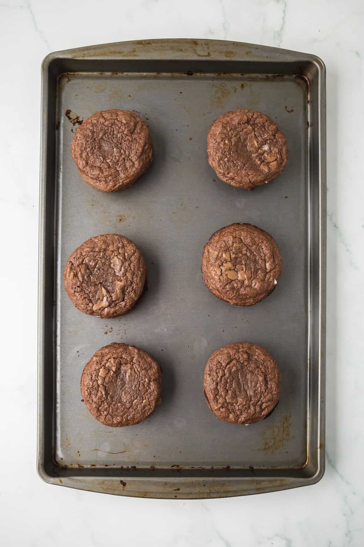 Freshly baked brownie cookies on a baking sheet after baking.
