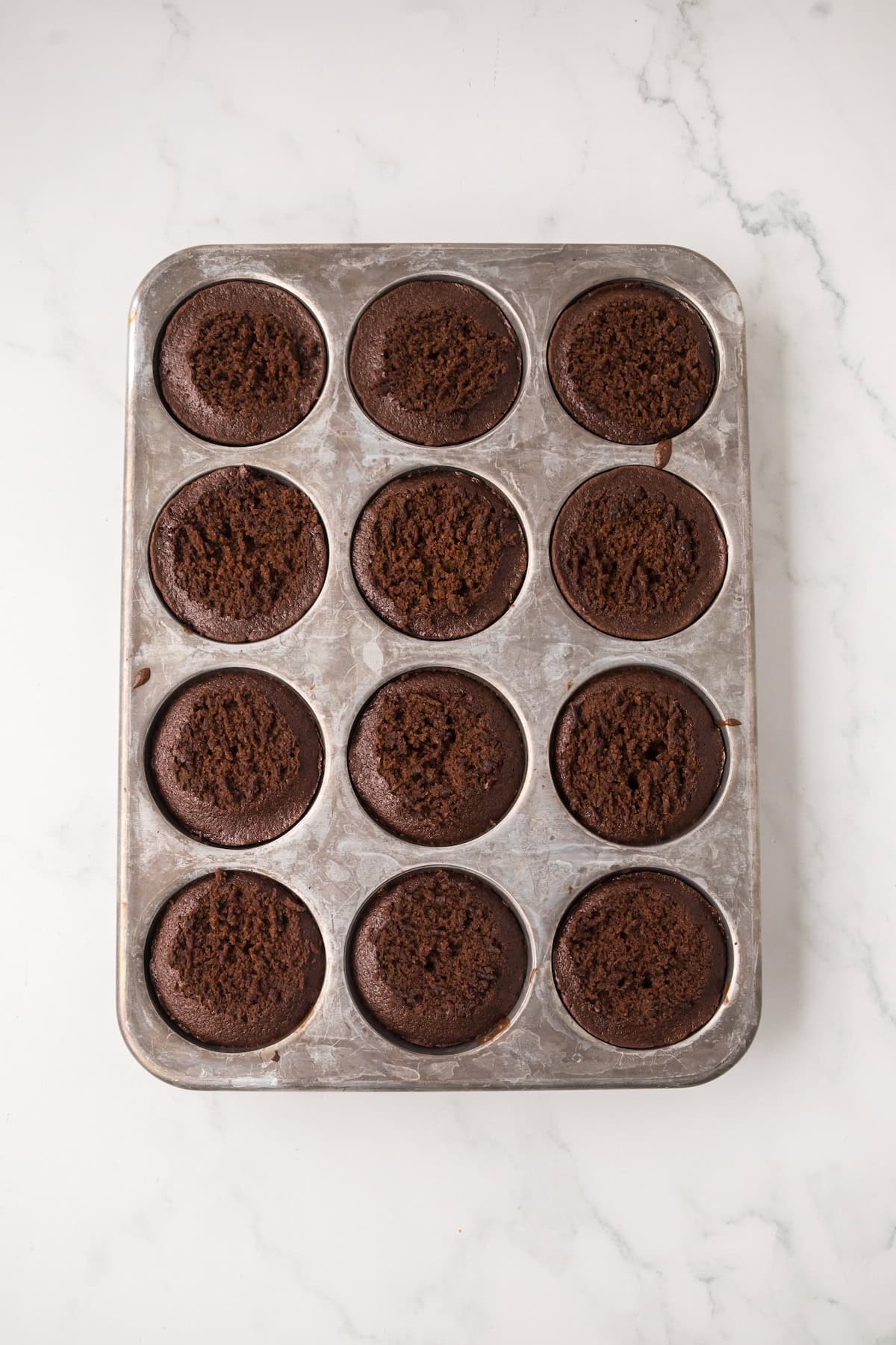 Baked chocolate cakes ready to be filled for homemade ding dongs