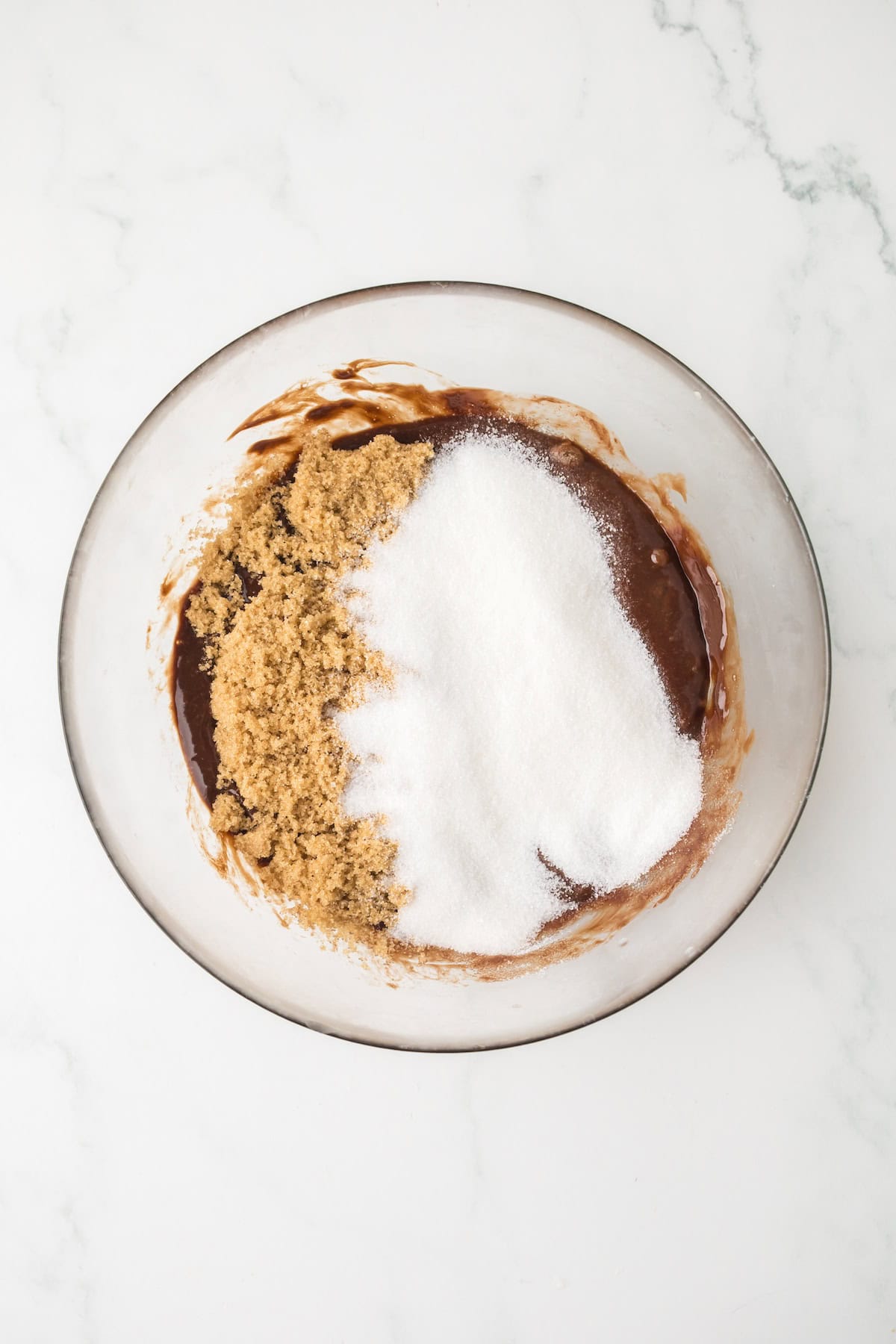 Granulated sugar and brown sugar added to melted chocolate mixture for brownie cream pies.