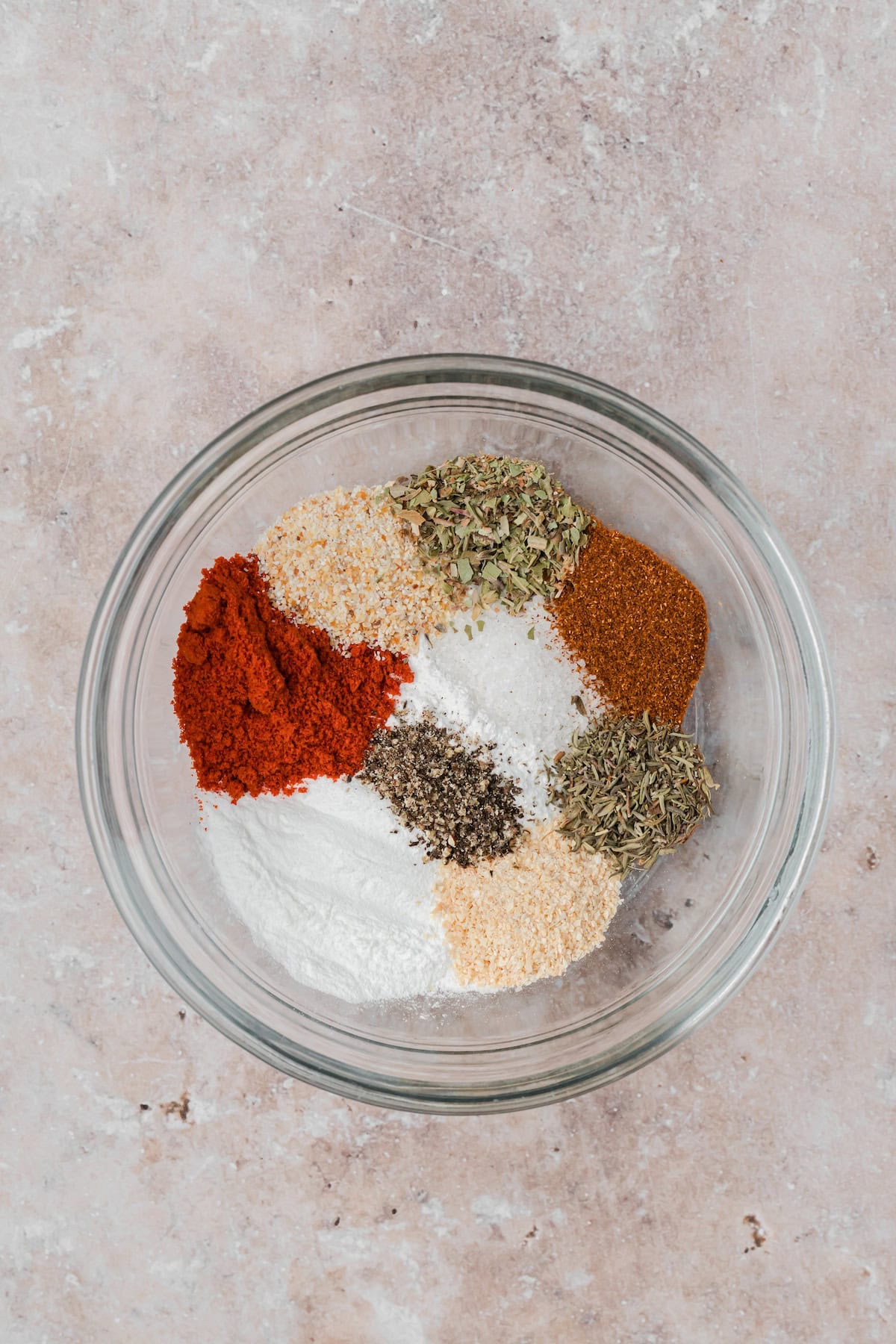 Cajun seasoning spices measured in a bowl before mixing.