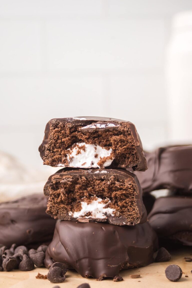 Stacked homemade Ding Dong halves showing chocolate cake layers and fluffy cream filling.
