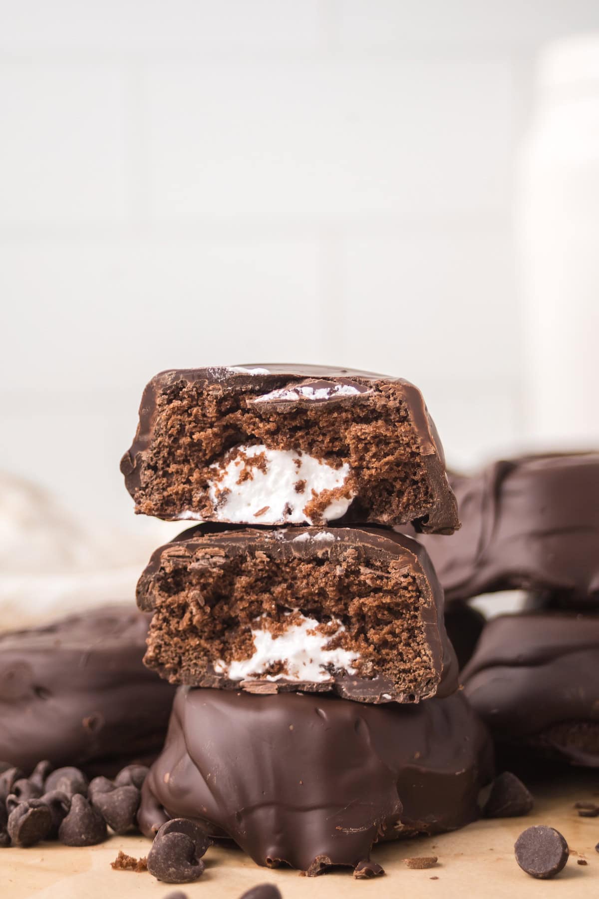 Stacked homemade Ding Dong halves showing chocolate cake layers and fluffy cream filling.
