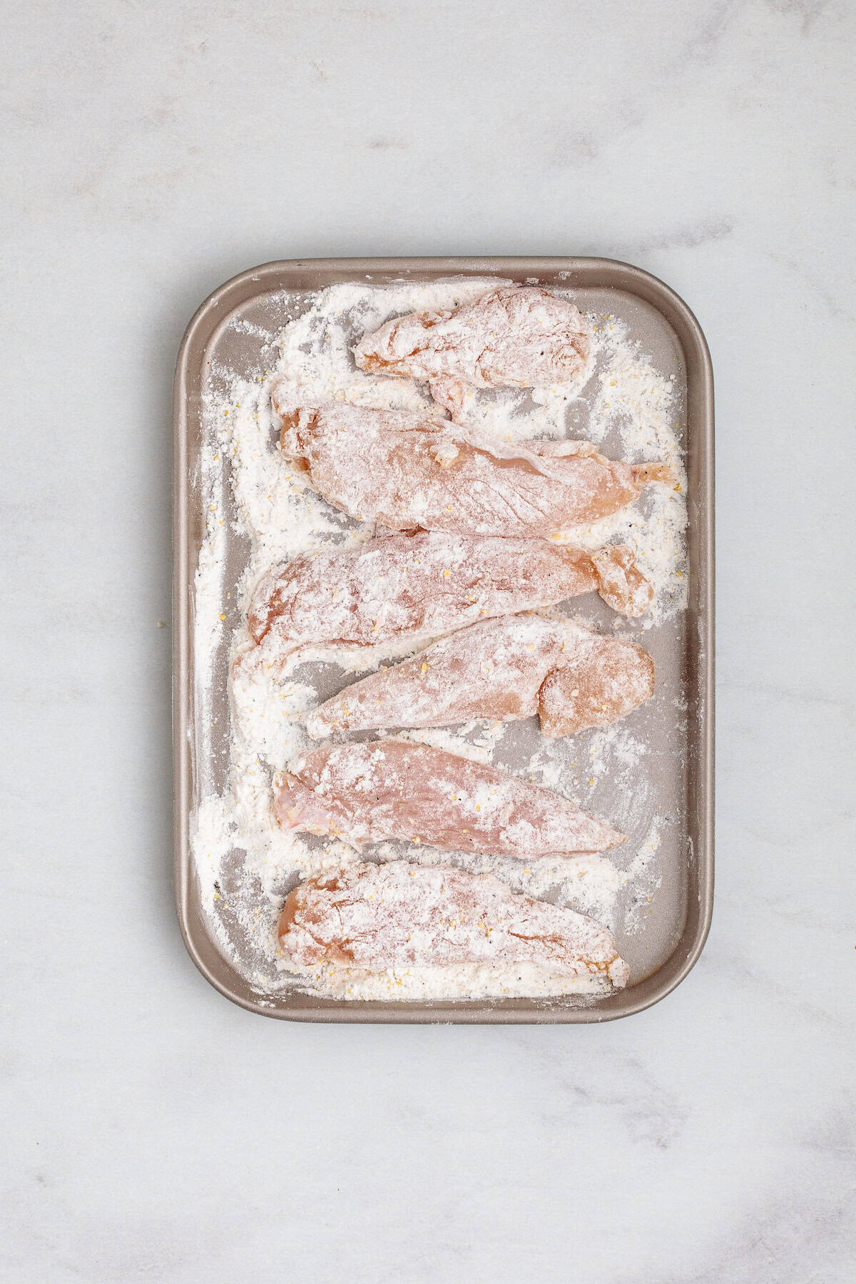 Golden chicken pieces seared in a Dutch oven for creamy chicken marsala fettuccine pasta.