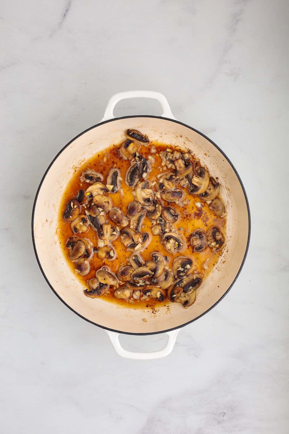 Sautéed mushrooms simmering in a rich Marsala wine sauce for creamy chicken Marsala fettuccine pasta.