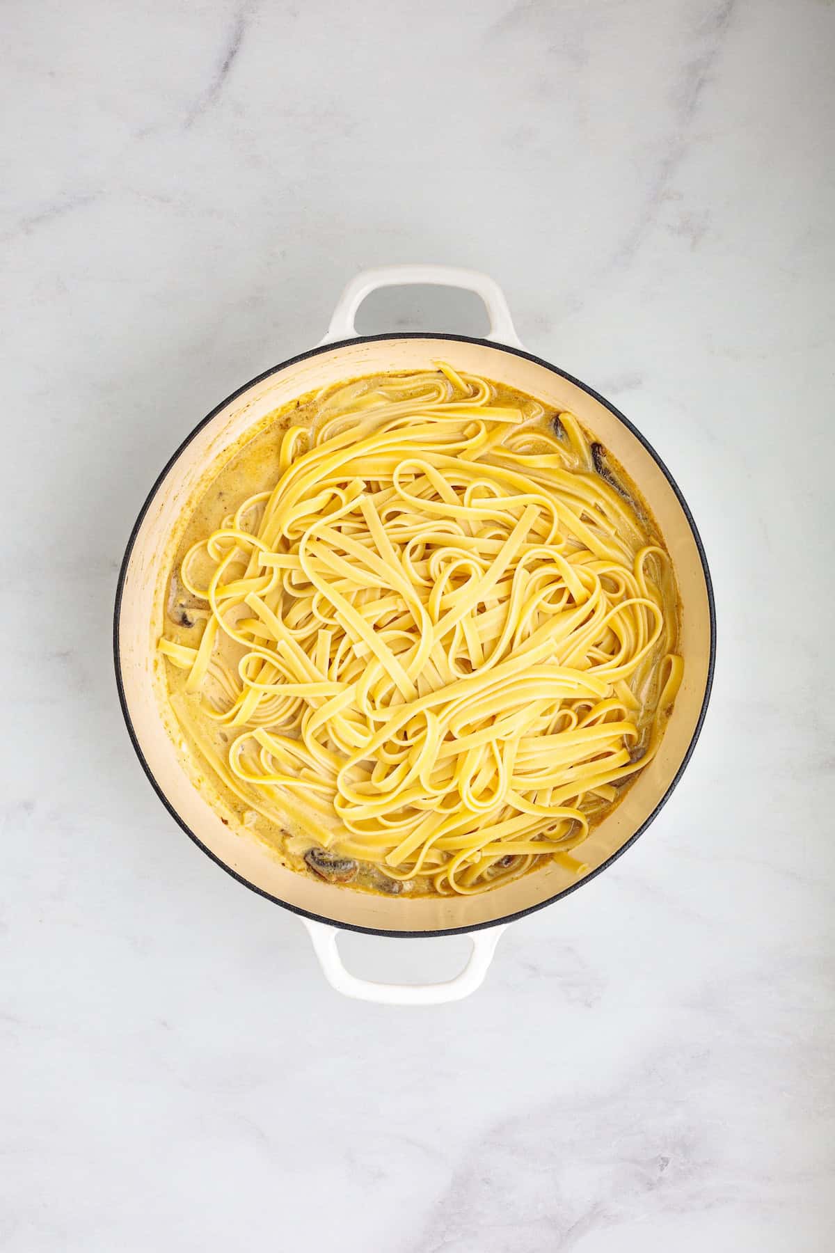 Fettuccine pasta tossed in a creamy Marsala mushroom sauce with Parmesan cheese for homemade chicken Marsala fettuccine.