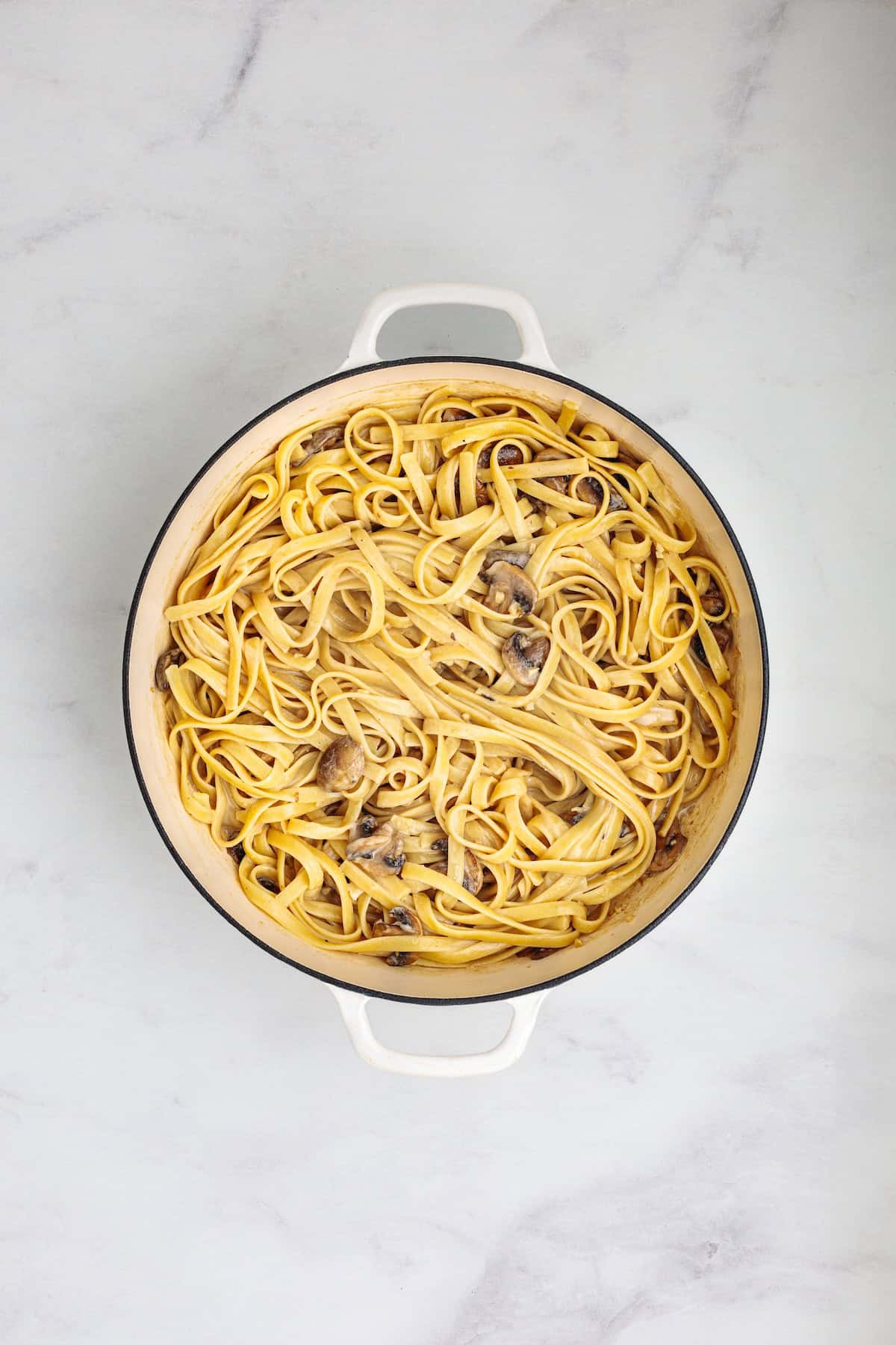 Fettuccine pasta tossed with creamy Marsala mushroom sauce for an easy homemade chicken Marsala fettuccine recipe.