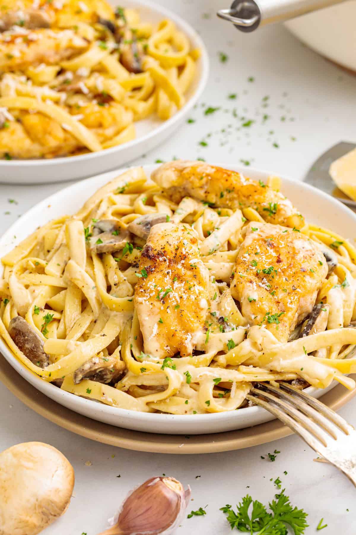 Creamy chicken Marsala fettuccine with golden pan-seared chicken, mushrooms, Parmesan cheese, and fresh parsley in a rich Marsala cream sauce.