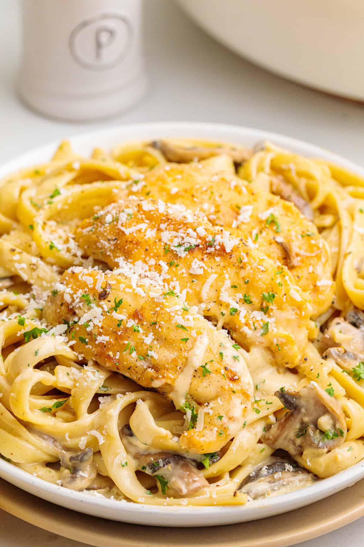 Creamy chicken marsala fettuccine topped with golden chicken, parmesan cheese, mushrooms, and fresh parsley.